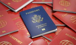 Passport of USA on the pile of passports of other countries. Immigration concept.